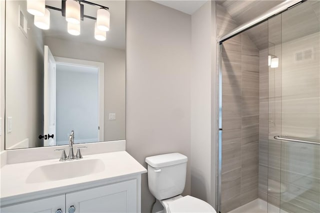 bathroom with walk in shower, toilet, and vanity