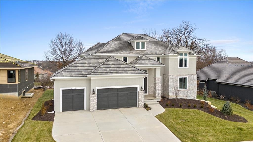 view of property with a garage and a front yard