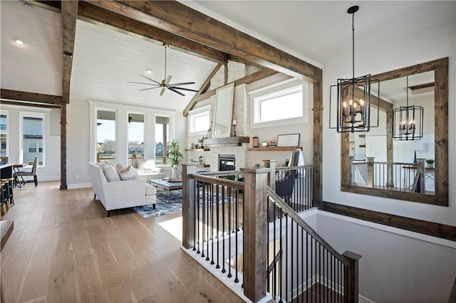 hallway with high vaulted ceiling, beam ceiling, a notable chandelier, and dark wood-type flooring