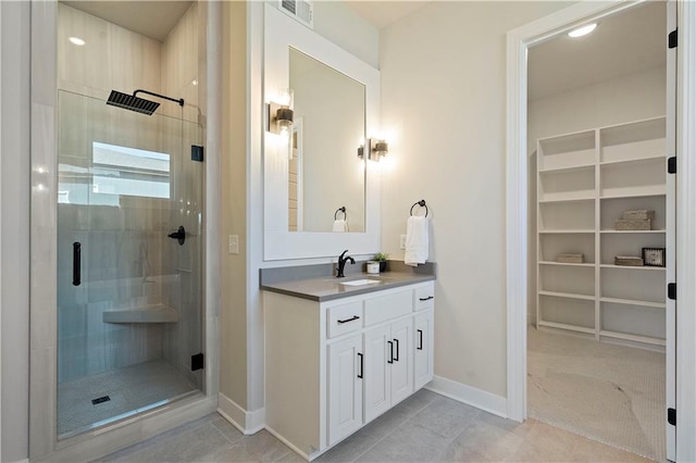 bathroom with tile floors, an enclosed shower, and oversized vanity