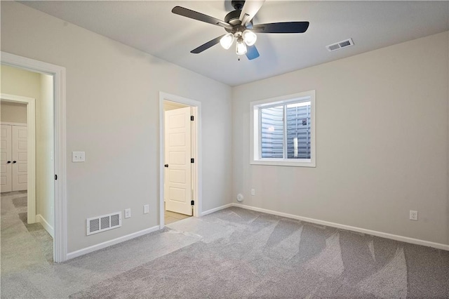 unfurnished bedroom featuring light carpet and ceiling fan