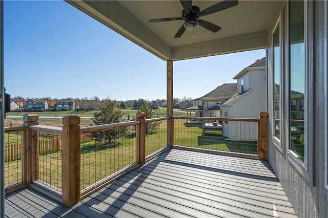 wooden deck featuring ceiling fan and a yard