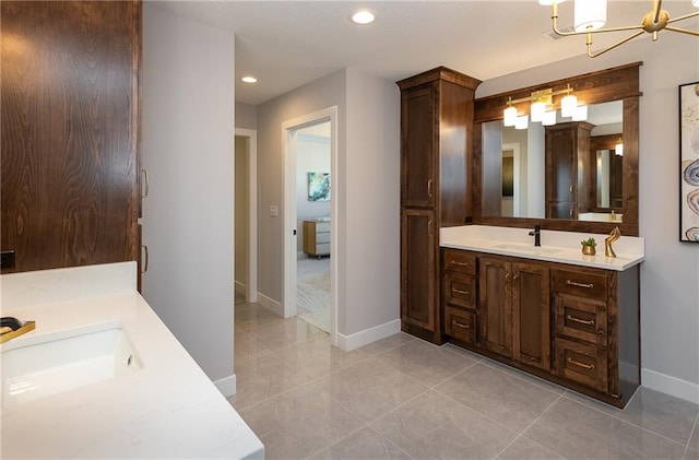 bathroom with vanity and an inviting chandelier