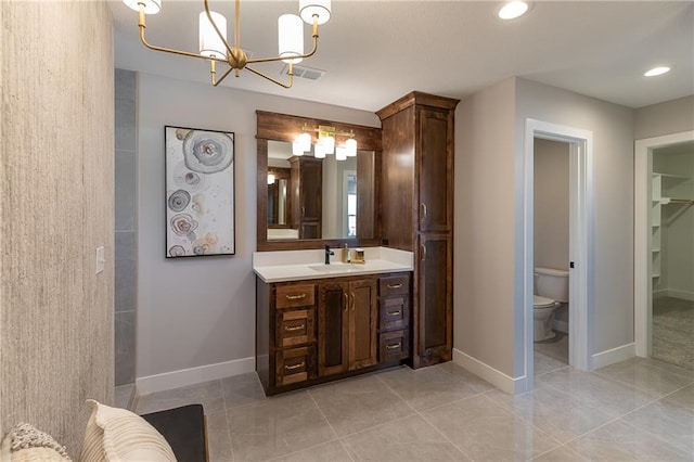 bathroom with vanity, a chandelier, toilet, and tile patterned floors