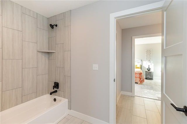 bathroom with tile patterned floors and tiled shower / bath combo