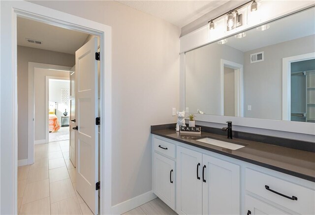 bathroom with vanity and tile patterned floors