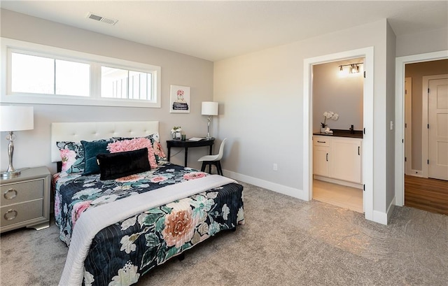 carpeted bedroom with ensuite bathroom