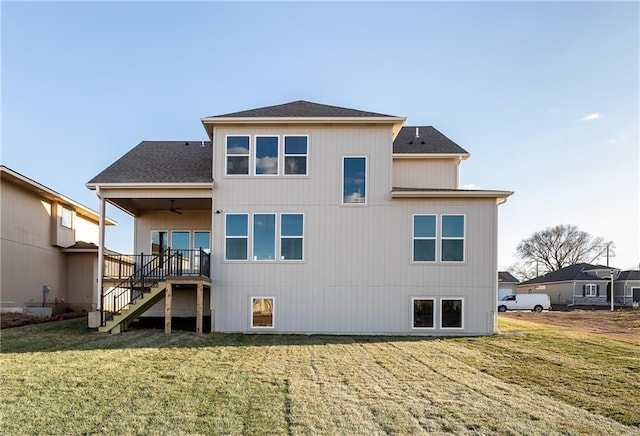 rear view of house with a yard and ceiling fan