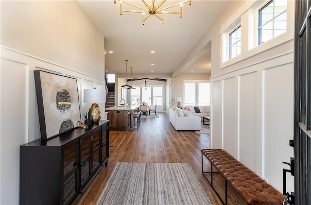 hall featuring a high ceiling, a chandelier, and dark hardwood / wood-style floors