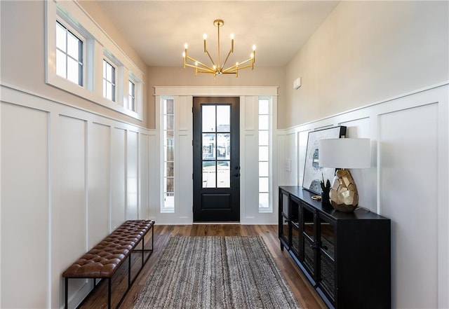 foyer with a notable chandelier and dark hardwood / wood-style floors