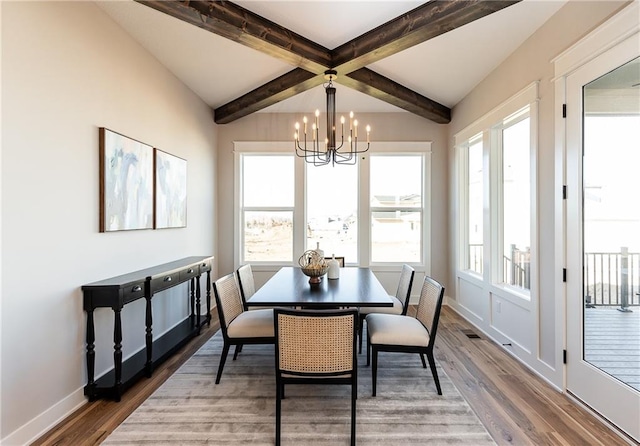 dining room featuring beamed ceiling, a chandelier, and hardwood / wood-style flooring