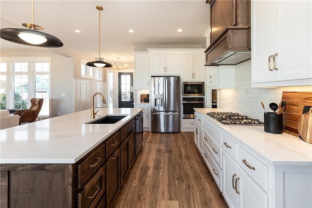 kitchen featuring sink, dark hardwood / wood-style flooring, white cabinetry, stainless steel appliances, and pendant lighting