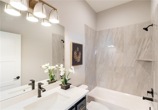 full bathroom featuring vanity, toilet, and tiled shower / bath