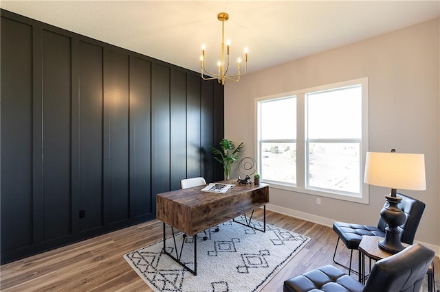 office space featuring a notable chandelier and light wood-type flooring