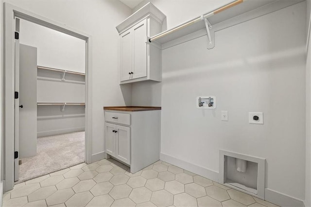 clothes washing area with light carpet, hookup for a washing machine, cabinets, and hookup for an electric dryer