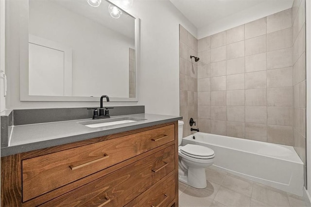 full bathroom featuring tile patterned flooring, vanity, toilet, and tiled shower / bath