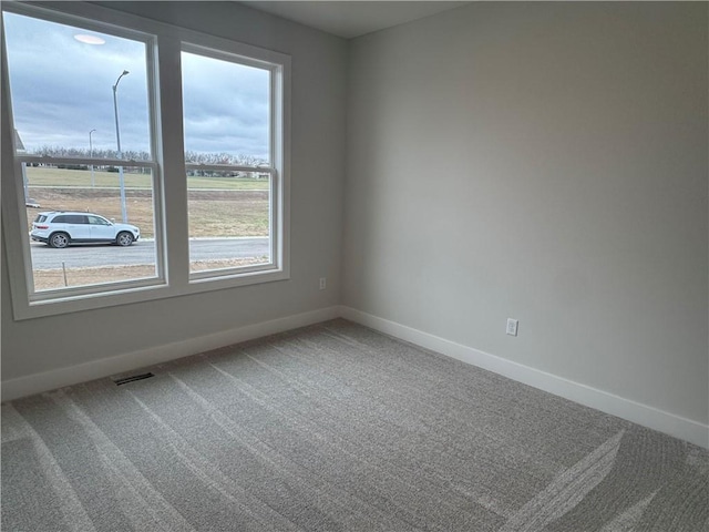 unfurnished room featuring carpet flooring