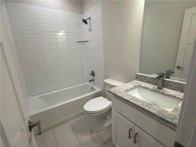 full bathroom featuring tile patterned floors, vanity, tiled shower / bath, and toilet