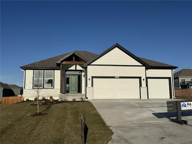 view of front of home featuring a front yard and a garage