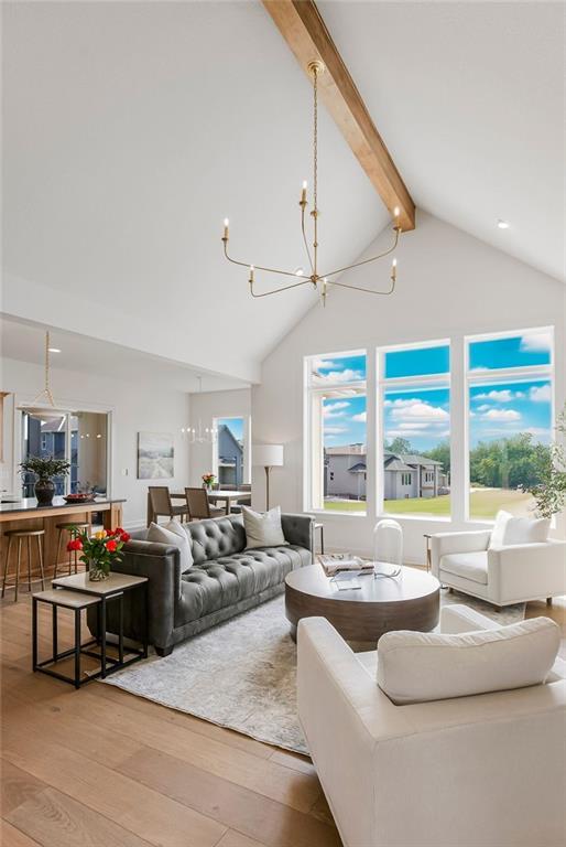 16735 S Hall St, Olathe, KS 66062 - living room with high vaulted ceiling, beam ceiling, light hardwood / wood-style floors, and a notable chandelier