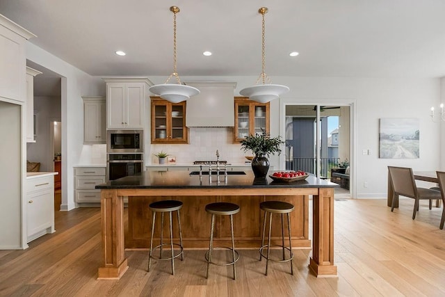 16735 S Hall St, Olathe, KS 66062 - kitchen featuring built in microwave, a center island, stainless steel oven, and custom range hood