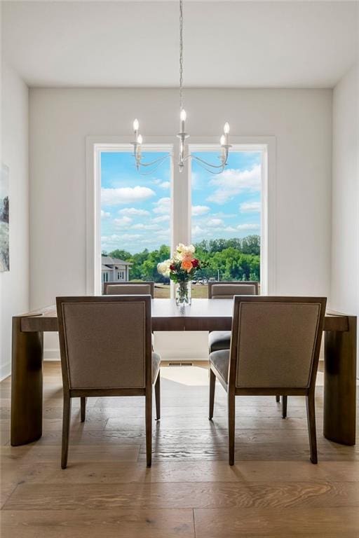 16735 S Hall St, Olathe, KS 66062 - dining area featuring wood-type flooring and an inviting chandelier