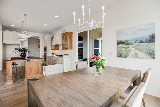 16735 S Hall St, Olathe, KS 66062 - dining space featuring sink, a notable chandelier, and light hardwood / wood-style flooring