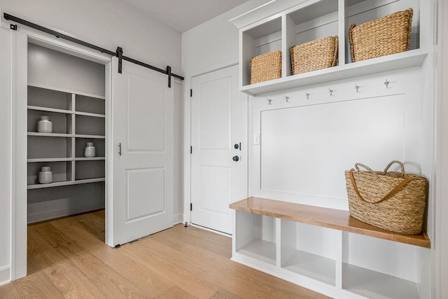 16735 S Hall St, Olathe, KS 66062 - mudroom featuring a barn door and light hardwood / wood-style floors