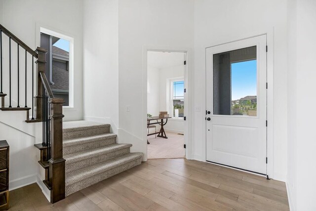 16743 S Hall St, Olathe, KS 66062 - foyer entrance featuring baseboards, light wood-style floors, and stairs
