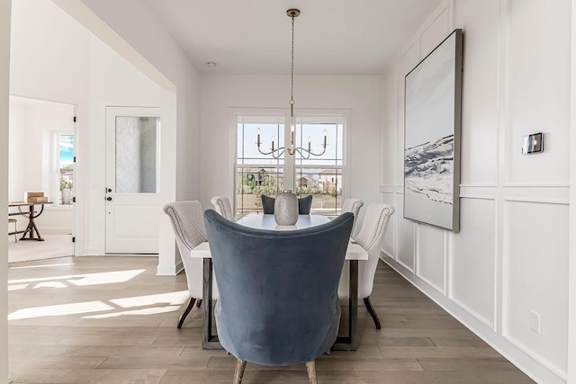 16743 S Hall St, Olathe, KS 66062 - dining room with a decorative wall, a notable chandelier, and wood finished floors