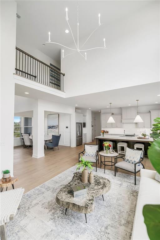 16743 S Hall St, Olathe, KS 66062 - living area with a chandelier, light wood finished floors, and recessed lighting