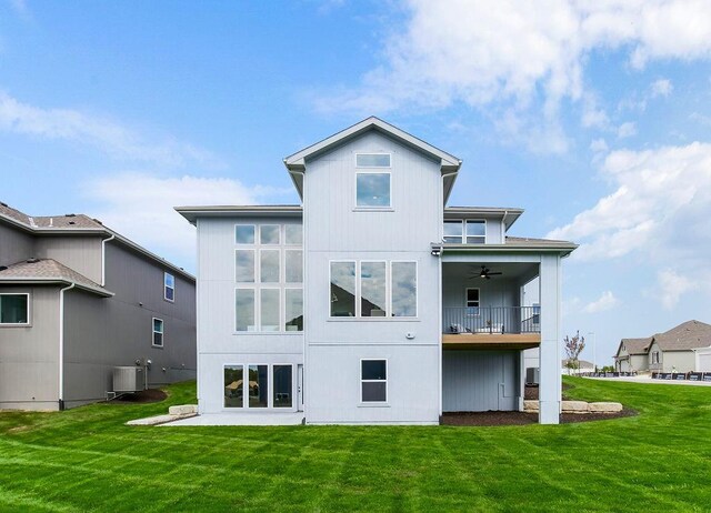 16743 S Hall St, Olathe, KS 66062 - rear view of property featuring central AC unit, ceiling fan, a patio, and a lawn