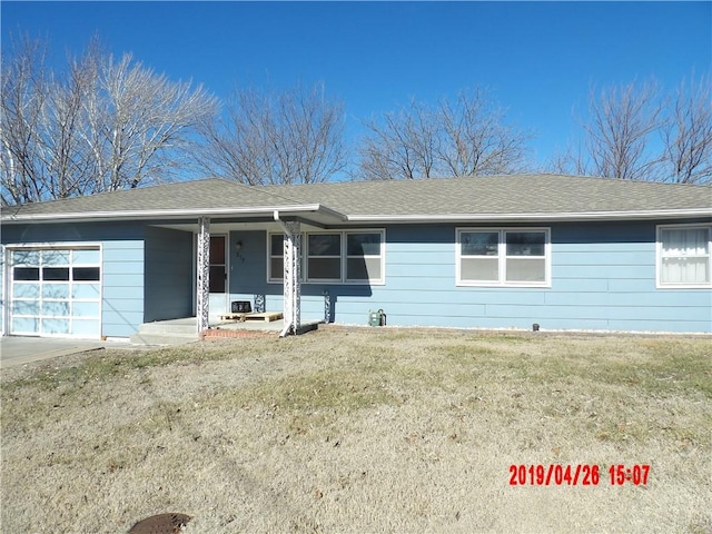 view of front facade with a front lawn and a garage