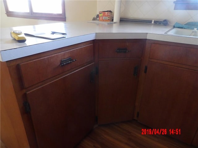 kitchen featuring tasteful backsplash, dark hardwood / wood-style flooring, and sink