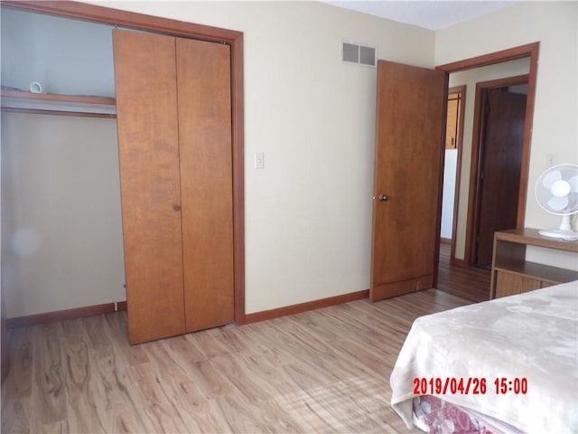 bedroom featuring a closet and light wood-type flooring