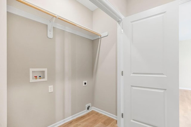 clothes washing area with hookup for a washing machine, laundry area, wood finished floors, baseboards, and electric dryer hookup