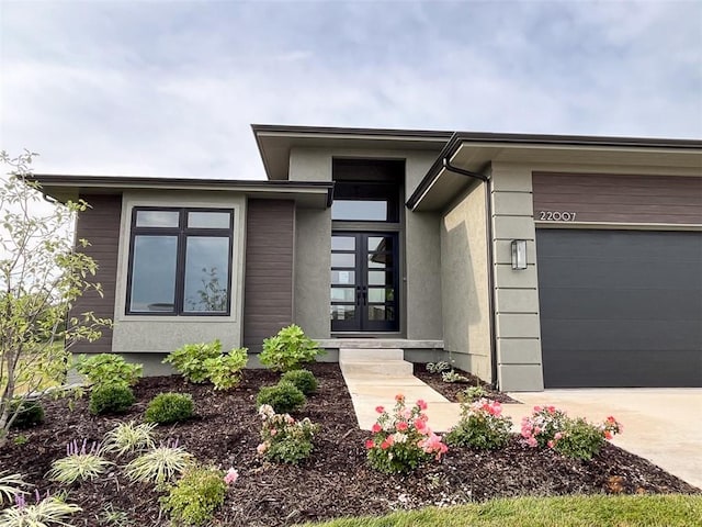 view of front of property with french doors and a garage