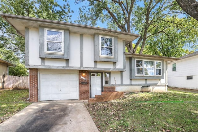 tri-level home with a garage and a front yard