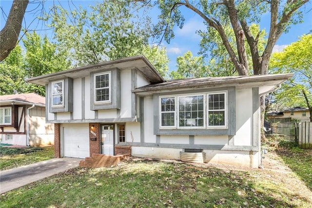 tri-level home with a front lawn and a garage