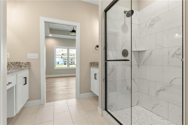 bathroom featuring ceiling fan, an enclosed shower, vanity, and tile floors