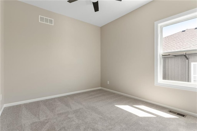 unfurnished room featuring ceiling fan and carpet floors