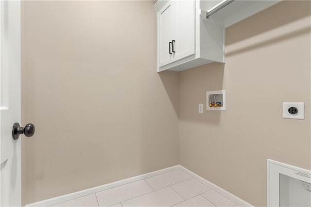 clothes washing area with electric dryer hookup, light tile flooring, cabinets, and hookup for a washing machine