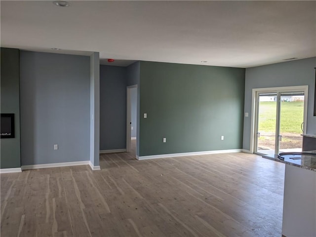 unfurnished living room with light hardwood / wood-style flooring