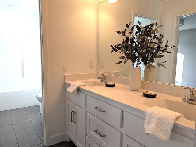 bathroom with vanity, tile patterned flooring, a tub, and toilet