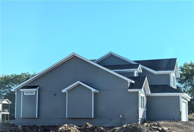 view of side of home featuring a garage