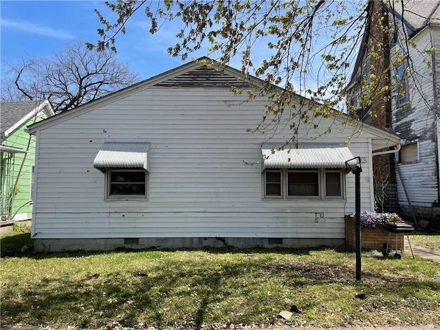 view of side of home featuring a lawn