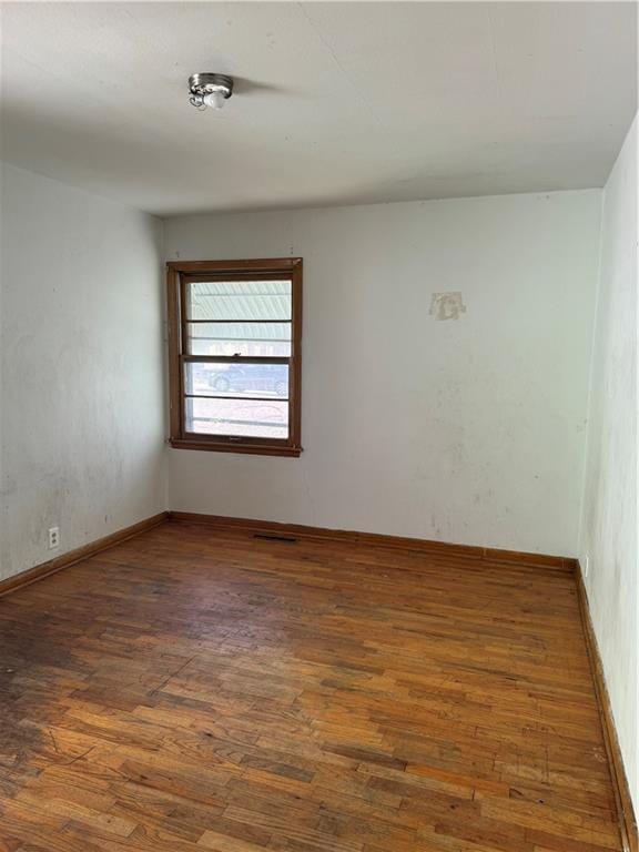 spare room with wood finished floors