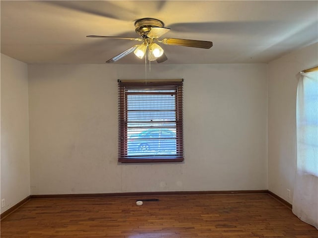 unfurnished room with wood finished floors, baseboards, and ceiling fan