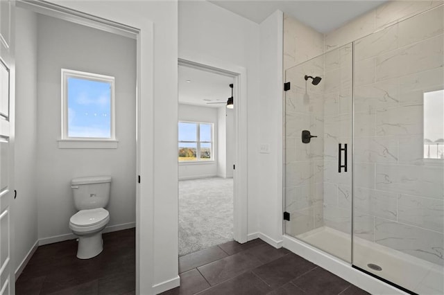 bathroom featuring toilet, tile patterned floors, ceiling fan, and a shower with shower door