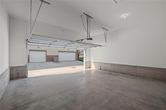 garage with central AC unit and a garage door opener